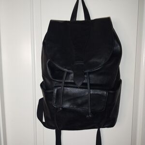 Black Canvas Backpack with Durable Fabric and Rounded Shape